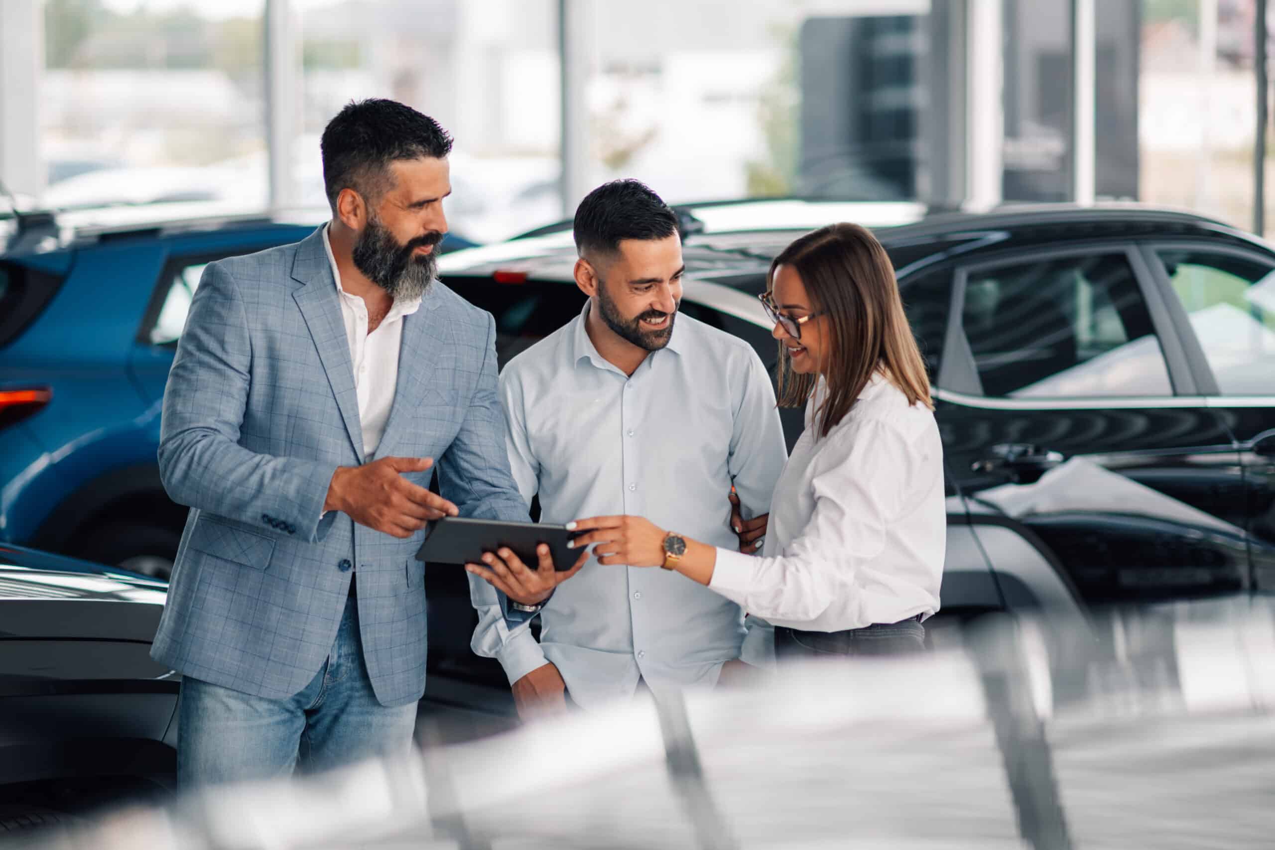 Showroom interaction showcasing car details on digital device.
